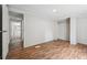 Clean bedroom with closet space and wood-look flooring, and hallway access with views of kitchen at 4820 Scott Rd, Cumming, GA 30041
