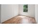 Bedroom featuring a bright window, wood-look flooring and ample natural light at 4820 Scott Rd, Cumming, GA 30041