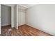 Simple bedroom provides closet space, wood-look floors, and doorway access to hallway at 4820 Scott Rd, Cumming, GA 30041