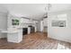 Modern kitchen features hardwood floors, black appliances, and white cabinets and countertops at 4820 Scott Rd, Cumming, GA 30041
