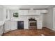 Cozy kitchen featuring wood floors, white cabinetry and stainless-steel appliances at 4820 Scott Rd, Cumming, GA 30041