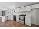 Bright kitchen showcasing light cabinetry, an oven, and wood flooring at 4820 Scott Rd, Cumming, GA 30041