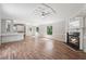 Bright living room with a fireplace, hardwood floors, and a ceiling fan at 4820 Scott Rd, Cumming, GA 30041