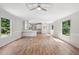 Bright, airy living room with hardwood floors, ceiling fan, and natural light pouring in at 4820 Scott Rd, Cumming, GA 30041