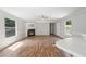 Bright and open living room with hardwood floors, fireplace, and large windows at 4820 Scott Rd, Cumming, GA 30041