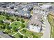 Aerial view of townhomes surrounded by well manicured landscaping, lawns and sidewalks at 6930 Whitman Walk, Alpharetta, GA 30005