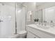 Beautiful bathroom featuring a glass shower door, white tiled shower walls, and a modern vanity with a sink at 6930 Whitman Walk, Alpharetta, GA 30005