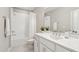 Bright bathroom with a tub-shower combo, stylish vanity with white countertop and mirror at 6930 Whitman Walk, Alpharetta, GA 30005