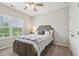 Cozy bedroom with a ceiling fan, comfortable bed, and bright natural light at 6930 Whitman Walk, Alpharetta, GA 30005