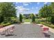 Charming gravel community area with pink seating and manicured landscaping at 6930 Whitman Walk, Alpharetta, GA 30005