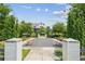 Inviting community area with gravel, charming pink seating, landscaping, and brick entryway at 6930 Whitman Walk, Alpharetta, GA 30005