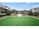 Inviting community area with a pergola, pink seating, and a lush green lawn at 6930 Whitman Walk, Alpharetta, GA 30005