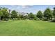 Expansive community green offers lush lawns, manicured landscaping, and inviting atmosphere at 6930 Whitman Walk, Alpharetta, GA 30005