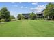 Large community green featuring benches, landscaping, and a pergola-covered seating area at 6930 Whitman Walk, Alpharetta, GA 30005
