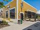 Exterior view of a commercial building with an outdoor dining area, showcasing architecture and landscaping at 6930 Whitman Walk, Alpharetta, GA 30005