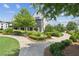 Condo exterior with beautiful landscaping, walkways, benches and trees in community space at 6930 Whitman Walk, Alpharetta, GA 30005