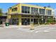 Exterior view of a commercial building with modern architecture and landscaping, featuring storefronts and parking area at 6930 Whitman Walk, Alpharetta, GA 30005