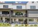 Townhome back exterior featuring outdoor seating area and upper level balcony at 6930 Whitman Walk, Alpharetta, GA 30005