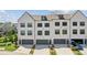 Beautiful townhome exterior showcasing three units, garage, and a well-maintained lawn at 6930 Whitman Walk, Alpharetta, GA 30005