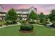 Well-maintained front lawn featuring beautiful statue and manicured landscaping for a pleasing aesthetic at 6930 Whitman Walk, Alpharetta, GA 30005