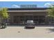 Modern Market Hall with a luxury car parked in front of the glass door entrance at 6930 Whitman Walk, Alpharetta, GA 30005