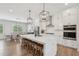 Modern kitchen with a large island, stainless steel appliances, and a dining area with stylish pendant lighting at 6930 Whitman Walk, Alpharetta, GA 30005