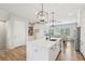 Bright kitchen featuring a large island, quartz countertops, stainless steel appliances, and modern pendant lighting at 6930 Whitman Walk, Alpharetta, GA 30005