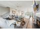 Spacious living room with hardwood floors, a fireplace, and an open layout connecting to the kitchen and dining area at 6930 Whitman Walk, Alpharetta, GA 30005