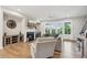 The open living room features a fireplace, hardwood floors, a ceiling fan and lots of natural light at 6930 Whitman Walk, Alpharetta, GA 30005