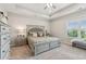 Main bedroom with neutral tones, tray ceiling, large window, and a comfortable, inviting feel at 6930 Whitman Walk, Alpharetta, GA 30005