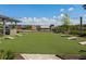 Outdoor lawn game area with cornhole boards, string lights and view of Big Creek at 6930 Whitman Walk, Alpharetta, GA 30005