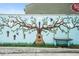 Vibrant outdoor mural featuring a tree with musical notes and an acoustic guitar at 6930 Whitman Walk, Alpharetta, GA 30005