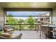 A cozy covered patio with outdoor seating offers scenic views of the surrounding neighborhood and greenery at 6930 Whitman Walk, Alpharetta, GA 30005