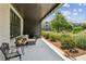 Inviting porch featuring cozy seating, a small table, and a view of the landscaped surroundings at 6930 Whitman Walk, Alpharetta, GA 30005