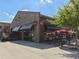 Kilwins exterior view featuring umbrellas and signage advertising chocolates and ice cream at 6930 Whitman Walk, Alpharetta, GA 30005