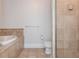Bathroom featuring tile floors, a soaking tub, toilet, a shower, and tile throughout at 825 Highland Ne Ln # 1116, Atlanta, GA 30306
