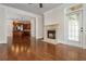Living room with fireplace, hardwood floors, and a view into the kitchen at 825 Highland Ne Ln # 1116, Atlanta, GA 30306