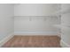 Walk-in closet featuring built-in shelving and carpeting at 825 Highland Ne Ln # 1116, Atlanta, GA 30306