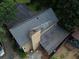 Aerial view of a house, highlighting the roof, chimney, and surrounding area at 1383 Natchez Sw Trce, Marietta, GA 30008