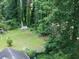 Aerial view of a spacious backyard, surrounded by lush trees at 1383 Natchez Sw Trce, Marietta, GA 30008