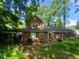 Exterior backyard view with the home, yard, grills and a partial patio at 1383 Natchez Sw Trce, Marietta, GA 30008