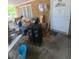 View of a covered patio with a white exterior door and various items stored there at 1383 Natchez Sw Trce, Marietta, GA 30008