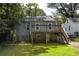 Home's backyard with wooden deck, stone foundation and stairs to the yard at 217 Rockyford Ne Rd, Atlanta, GA 30317