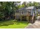 Home's backyard features wooden deck, stone foundation, grass and driveway at 217 Rockyford Ne Rd, Atlanta, GA 30317