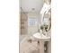 Classic bathroom features a pedestal sink, tiled floors, and a shower-tub combination at 217 Rockyford Ne Rd, Atlanta, GA 30317
