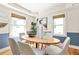 Cozy dining room with a wooden table, modern chairs, and wainscoting at 217 Rockyford Ne Rd, Atlanta, GA 30317
