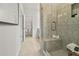 Modern shower stall with a tiled bench, glass enclosure, and view to the closet at 404 Nix Ln, Lawrenceville, GA 30046