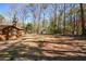 Large backyard with a storage shed, a wooded area and view of house at 4800 Timber Ridge Dr, Douglasville, GA 30135