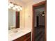 Bathroom vanity with modern faucet, mirror, and access to bedroom at 4800 Timber Ridge Dr, Douglasville, GA 30135