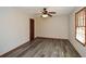 Cozy bedroom with gray wood floors, ceiling fan, window, and neutral paint at 4800 Timber Ridge Dr, Douglasville, GA 30135
